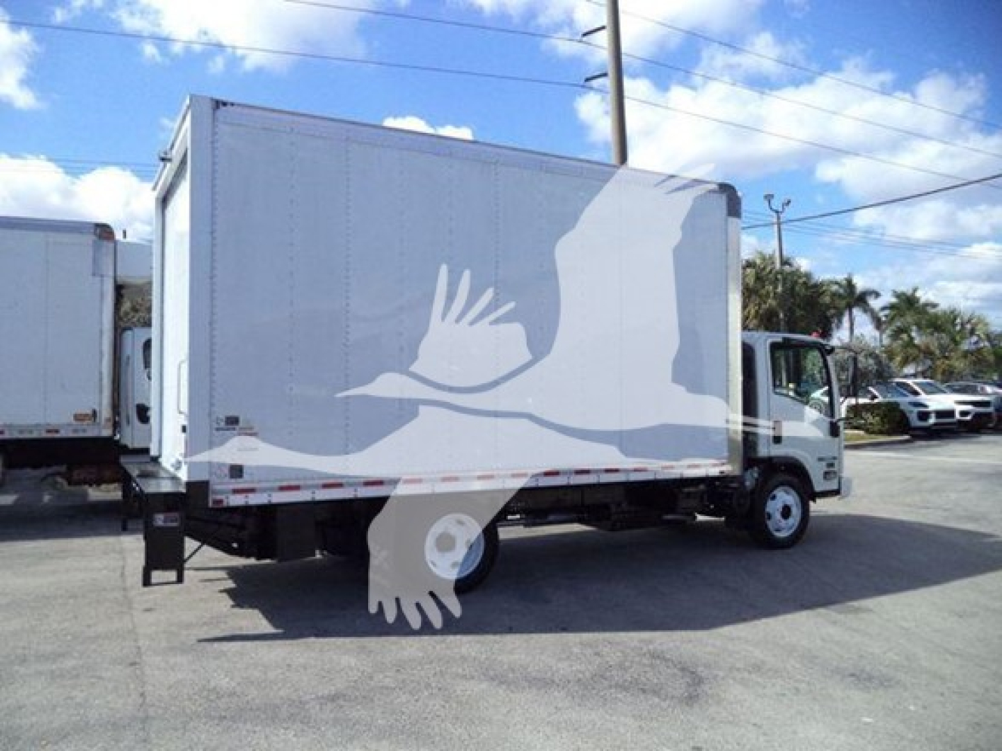 Isuzu NPR HD box truck in-service showing cargo box and cab from passenger side.