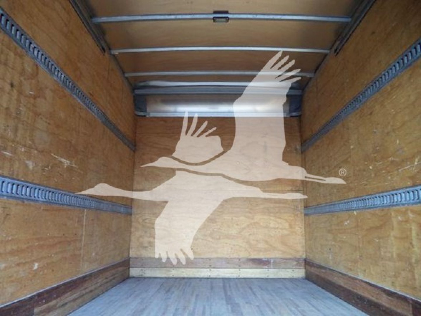 Isuzu NPR HD box truck cargo area interior with wooden walls and metal rails