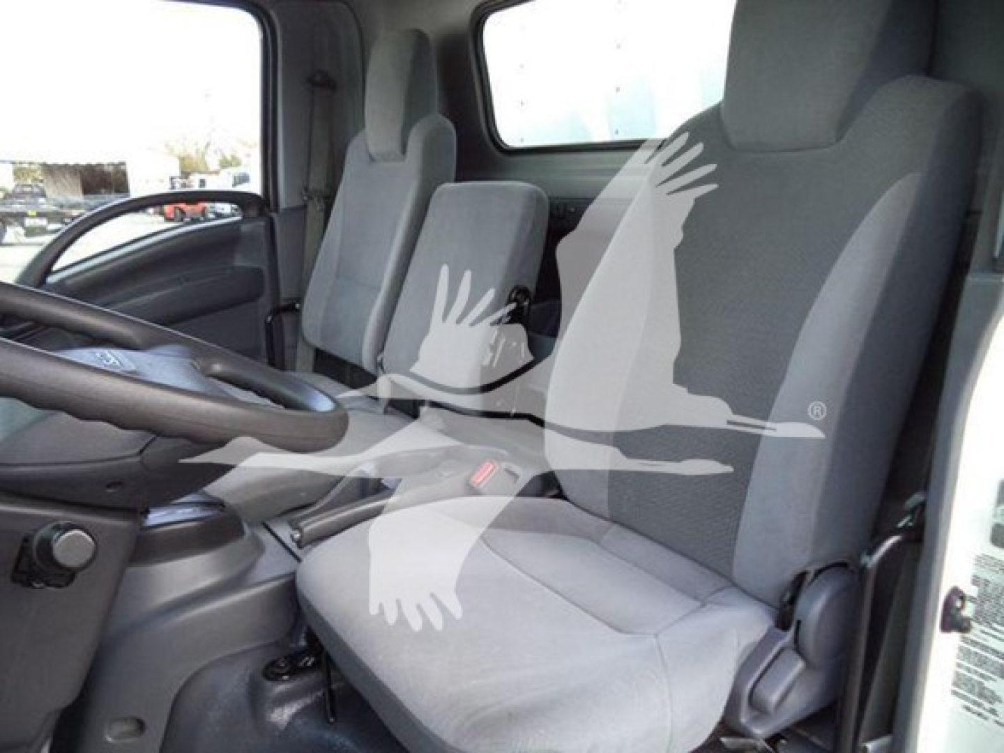 Isuzu NPR HD truck cabin interior showing front seats and steering wheel