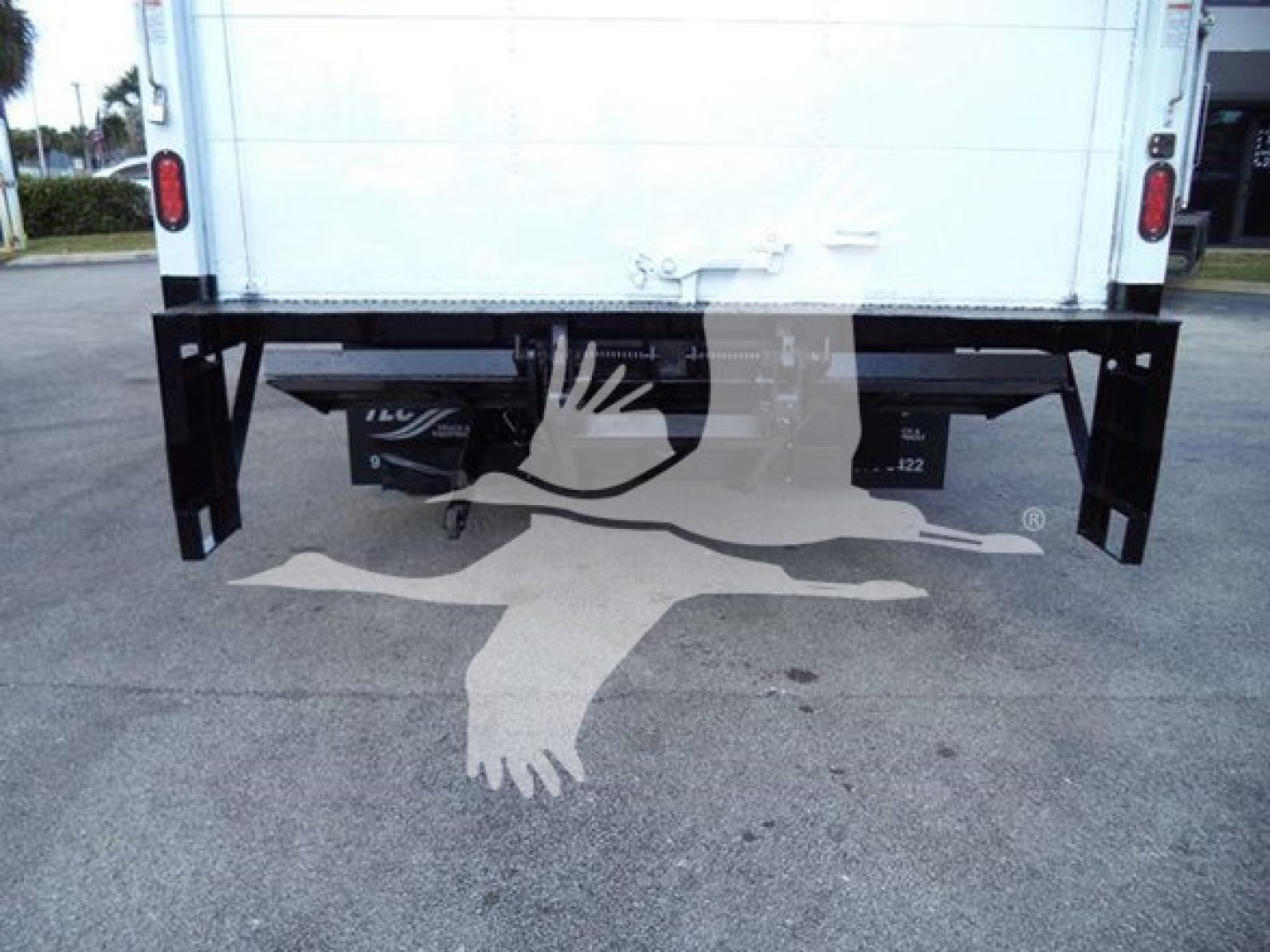 Isuzu NPR HD rear view showing bumper and hitch area with truck bed and frame components visible.