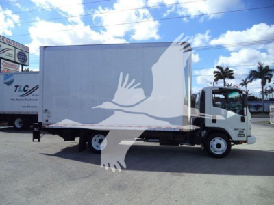 Isuzu NPR HD box truck in a lot with blue sky and clouds. Side of box shows large white bird watermark overlay. Cab visible with dual rear wheels.