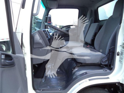 Isuzu NPR HD truck interior cab view showing driver seat and passenger seat, steering wheel, dashboard, and entry area.