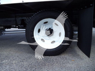Isuzu NPR HD truck wheel and fender with white steel wheel and tire, underbody view.