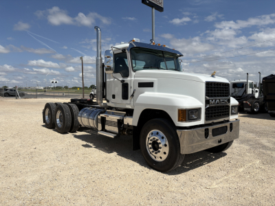 Truck image: 2027 Mack PI64T conventional daycab, white exterior, front grille with MACK logo, dual exhaust stacks, six-wheel tractor chassis, stock number 73282.