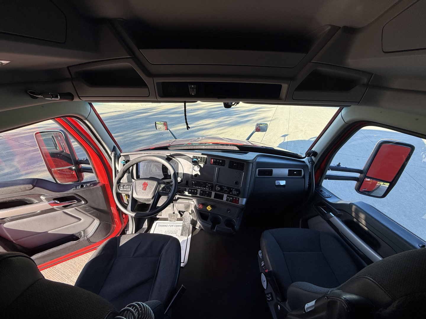 Kenworth T680 truck interior cab view with steering wheel and dashboard