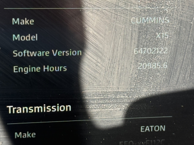Truck dashboard label showing Make Cummins, Model X15, Software Version 64702122, Engine Hours 20985.6, Transmission Make Eaton.