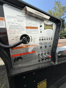 Landoll trailer control panel showing operating labels, warnings, and Andoll logo. Includes text such as TRAILER OPERATION, WARNING labels, and various switch/knob labels.