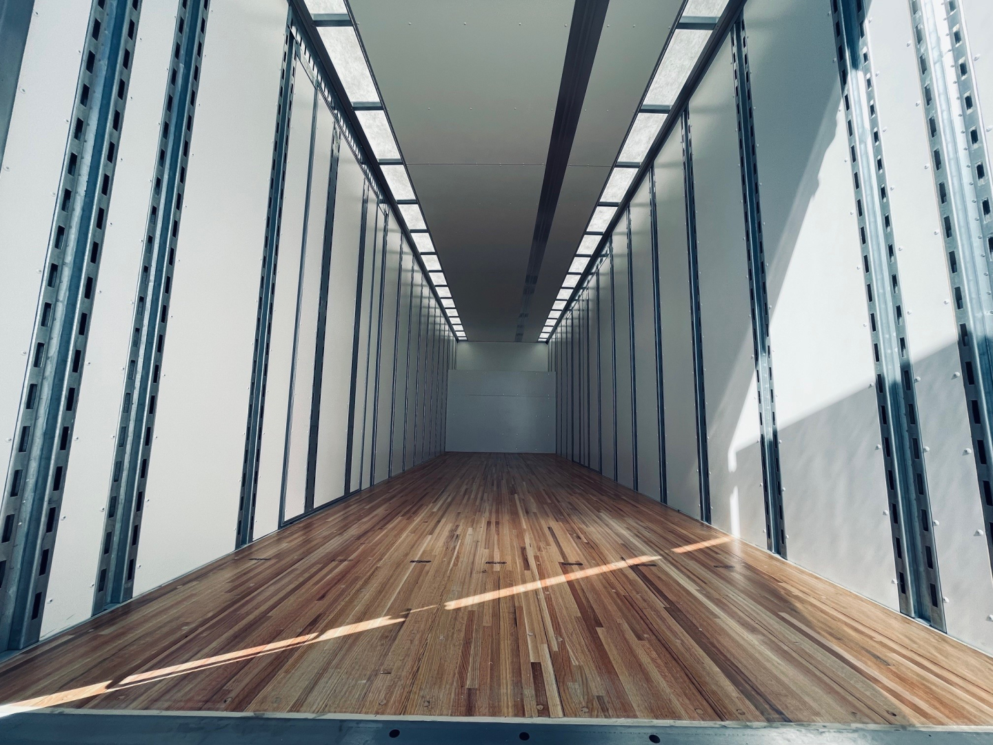 Mack MD6 truck interior cargo box showing wooden floor and sidewall rails