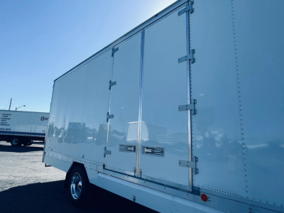 Box truck side view showing large cargo box with double rear doors and latches.