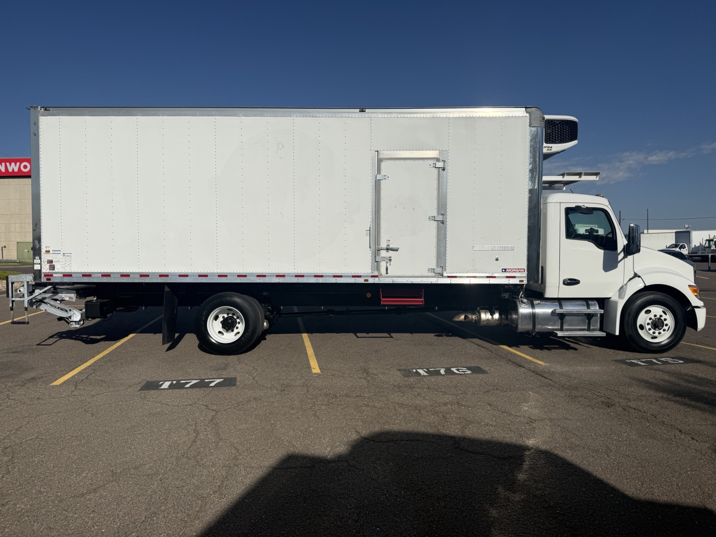 Kenworth T380 refrigerated truck side view showing cargo box, cab, and front wheel.