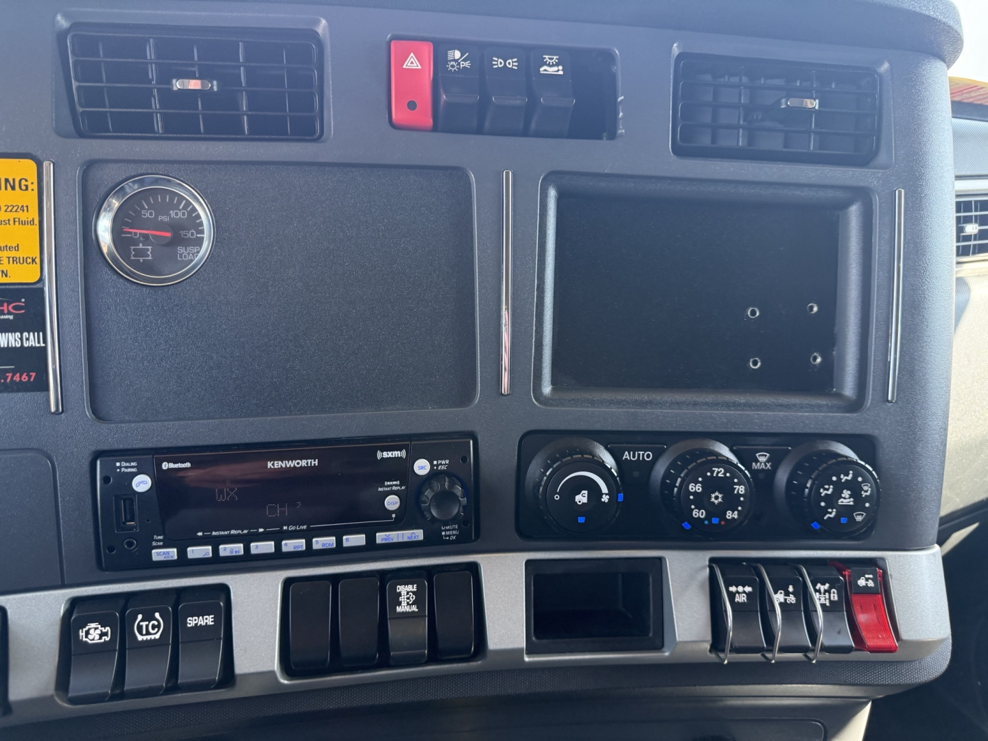 Kenworth T680 dash panel with gauges, vents, and control switches visible in the cockpit.
