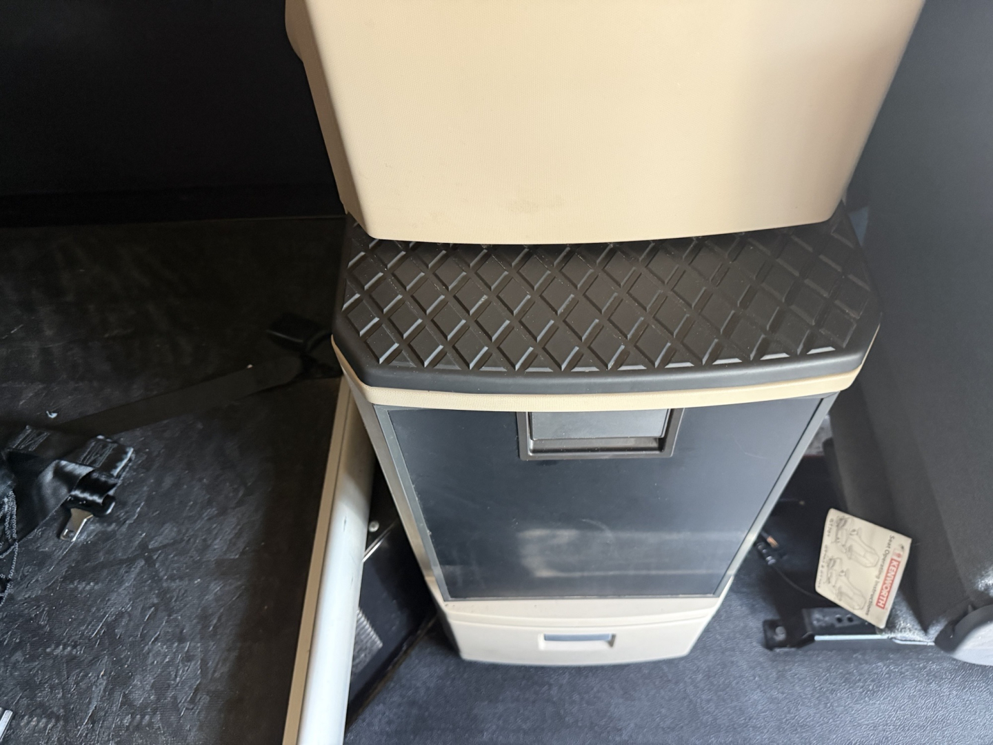 Kenworth T680 cab interior showing center console with diamond-plate step and storage drawer.