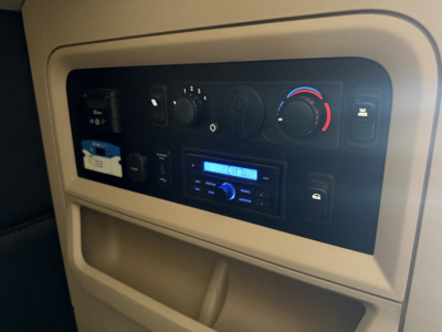 Kenworth T680 dash panel with climate controls and stereo display visible in the cab interior.