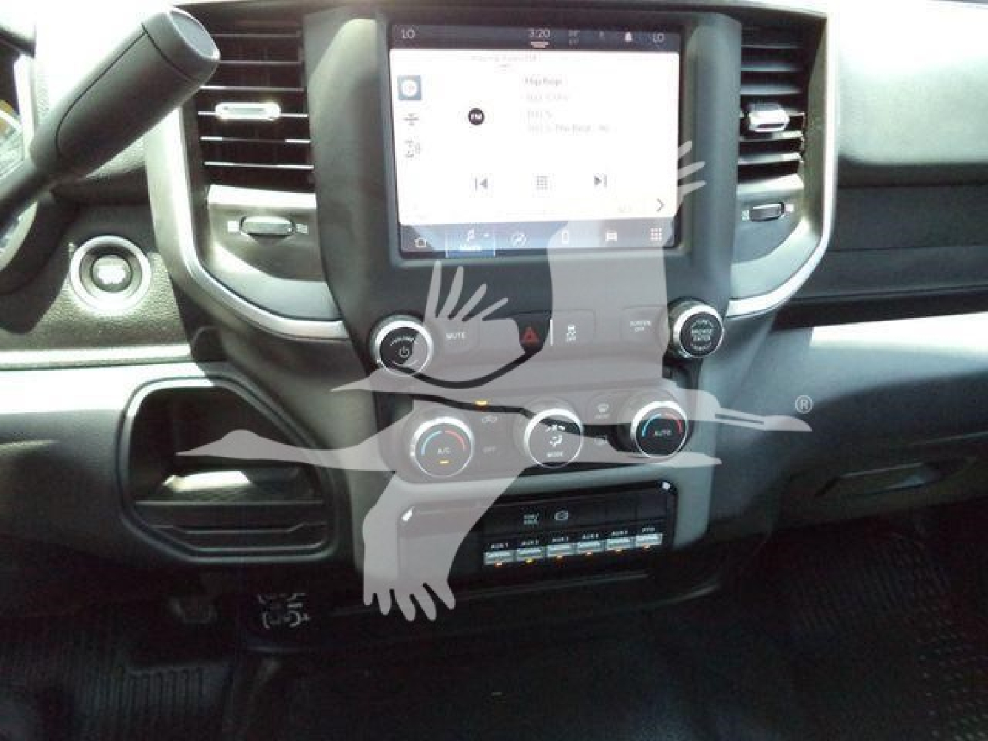 Ram 5500 cab interior showing center touchscreen display, climate controls, and lower storage area.