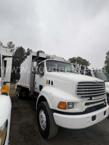 Truck front and left side of a Sterling LT8500 utility refuse vehicle chassis with white cab and large grill, showing side mirror and headlight details.