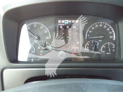 Dashboard view of a Freightliner M2 106 Plus instrument cluster with gauges and a central digital display.