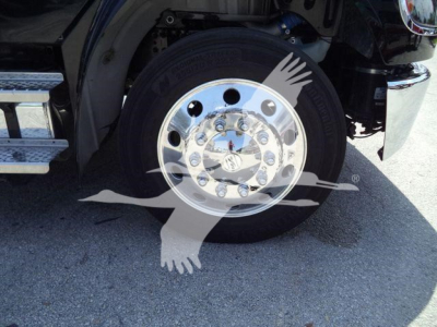 Front right wheel and hub of a Freightliner M2 106 Plus truck showing chrome wheel and tire, fender, and part of step edge.