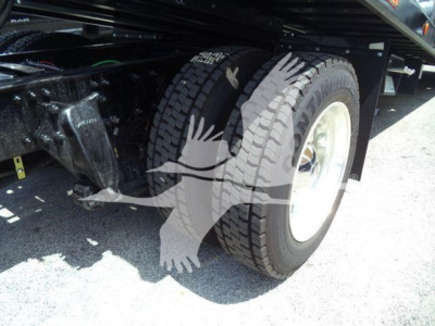 Freightliner M2 106 Plus truck rollback chassis showing front wheel and suspension components.