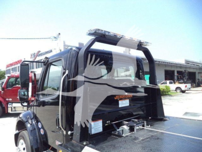 Freightliner M2 106 Plus rollback truck, rear view with loading deck and hydraulic system components visible.