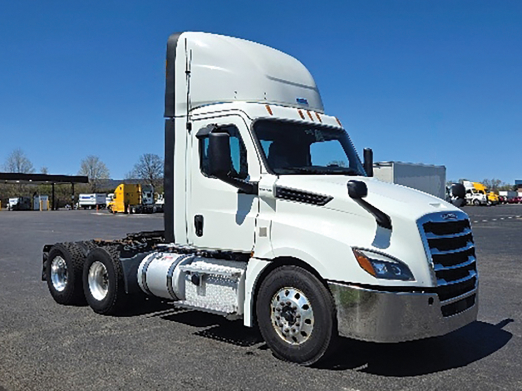 Truck cab and chassis of a Freightliner Cascadia 126 in-service, side view showing front grille, cab, and dual rear axles