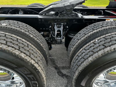 Kenworth T680 chassis with dual rear axles and suspension hangar; viewed from behind showing frame and drive components.