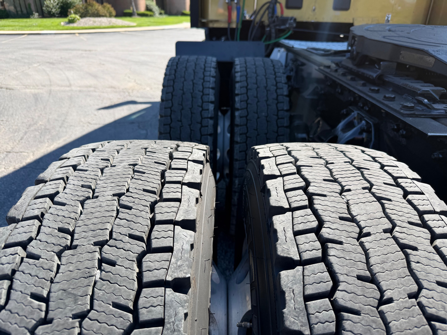 Kenworth truck rear view showing dual rear tires on a conventional sleeper truck.