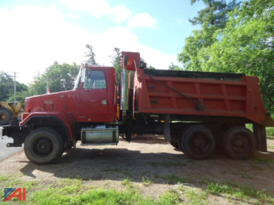 Volvo ACL dump truck side view showing red dump bed and heavy chassis.