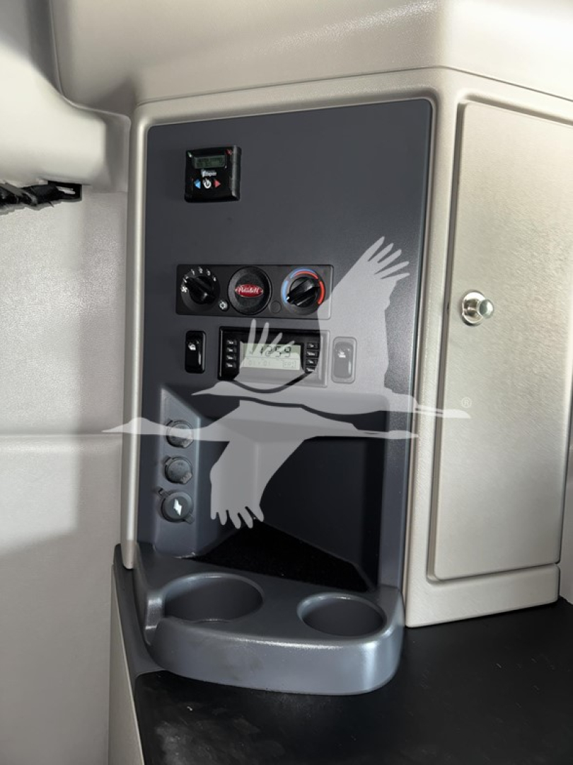 Peterbilt 579 dash area with controls and cup holder visible, interior cab paneling