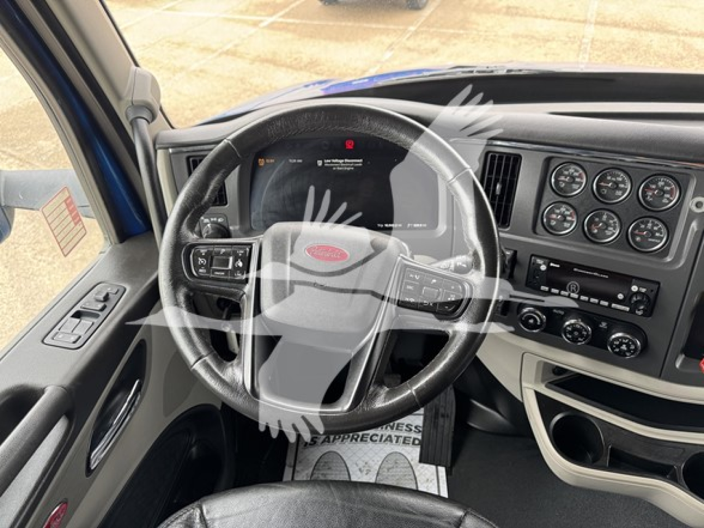 Peterbilt 579 truck interior showing steering wheel and instrument cluster with dashboard controls.