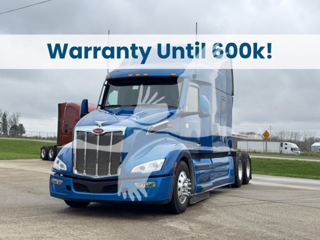 Peterbilt 579 truck in blue, front angle view with warranty banner across top of image.