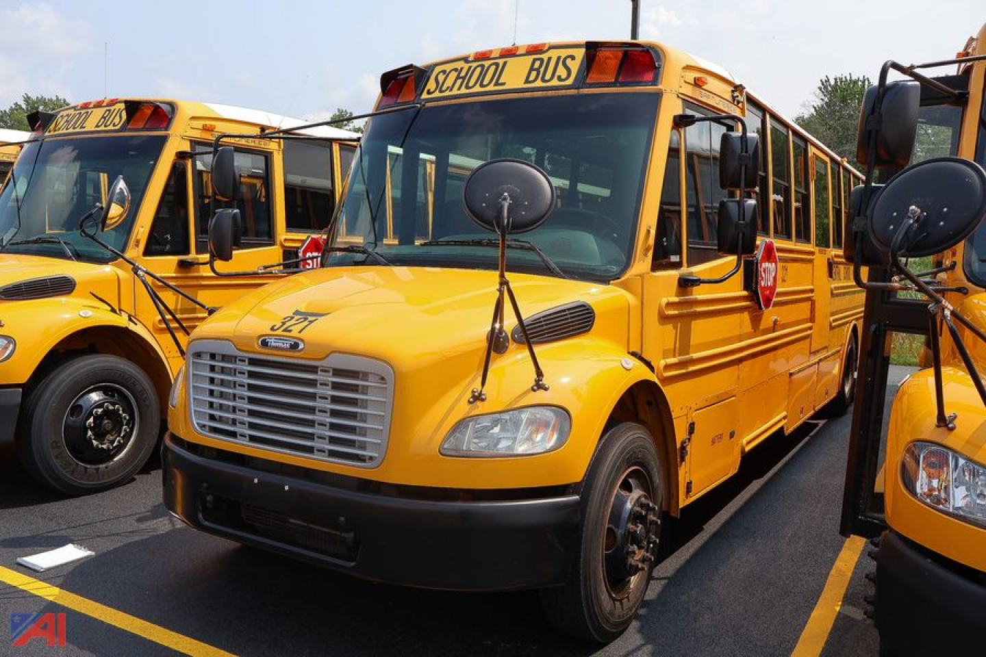 Yellow Freightliner Thomas Saf-T-Liner school bus showing front and side with school bus sign and stop sign graphic