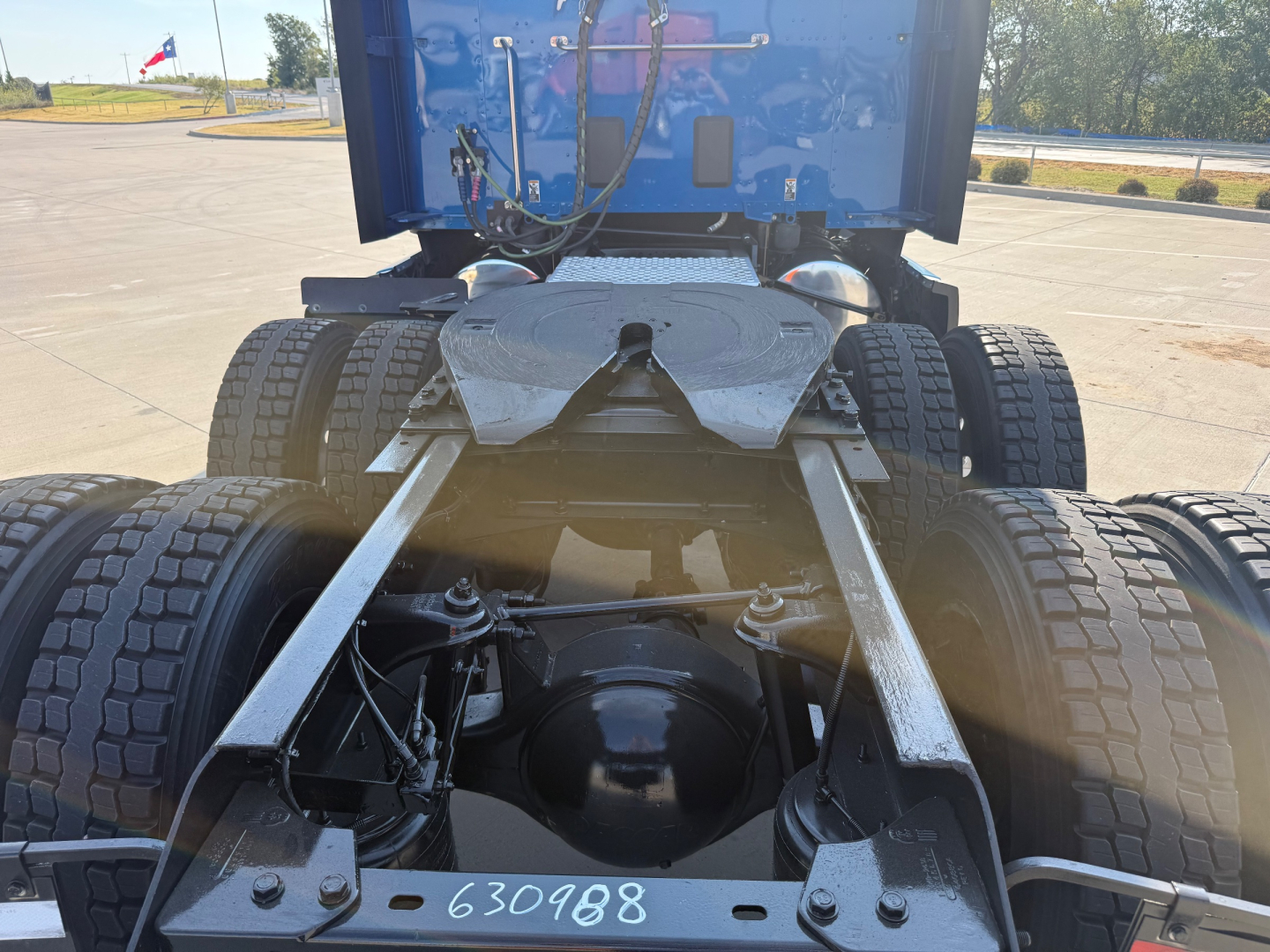 Kenworth T680 chassis rear view showing dual rear axles and fifth wheel mounting with visible chassis frame and suspension components.