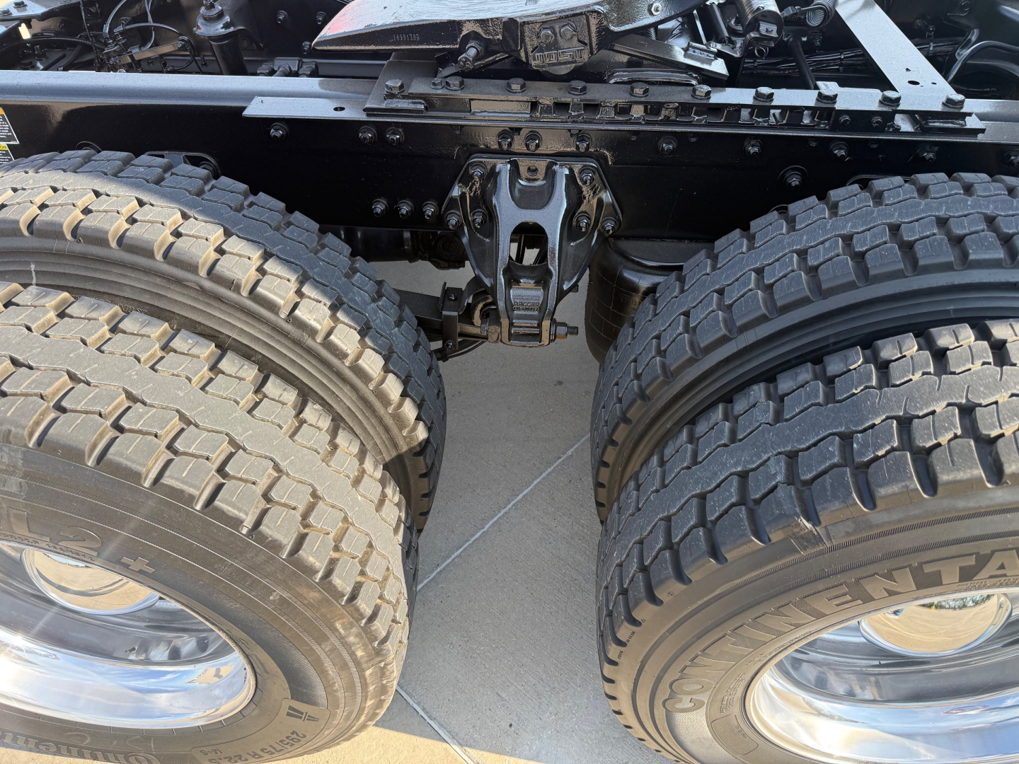 Kenworth T680 dual rear wheels showing heavy-duty suspension and tires with rims.