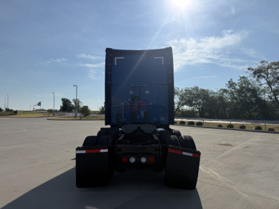 Kenworth T680 rear view showing fifth wheel, dual rear axles, and rear bumper with lights.