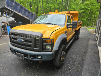 Ford F-450 dump truck in-service shown from front-right, yellow cab and dump bed, VIN 1FDAW4HR4AEA80769 visible on listing photo.