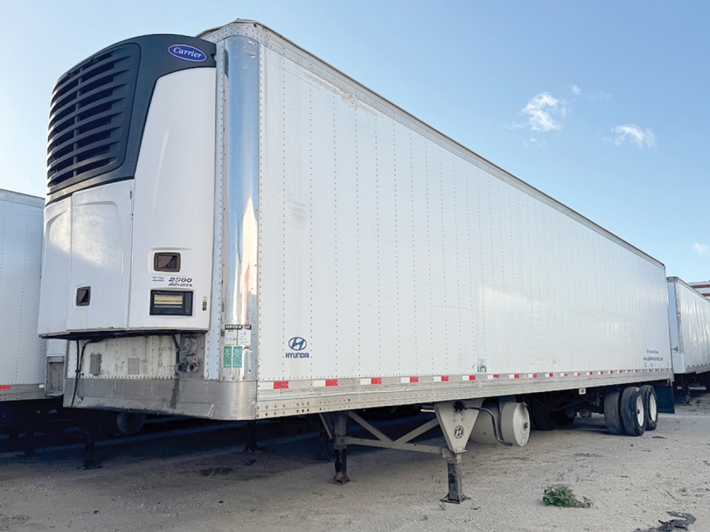 Hyundai aluminum reefer trailer with Carrier refrigeration unit showing front left, VIN 3H3V482C97T363011, stock 553172, white corrugated edges and dual rear axles.