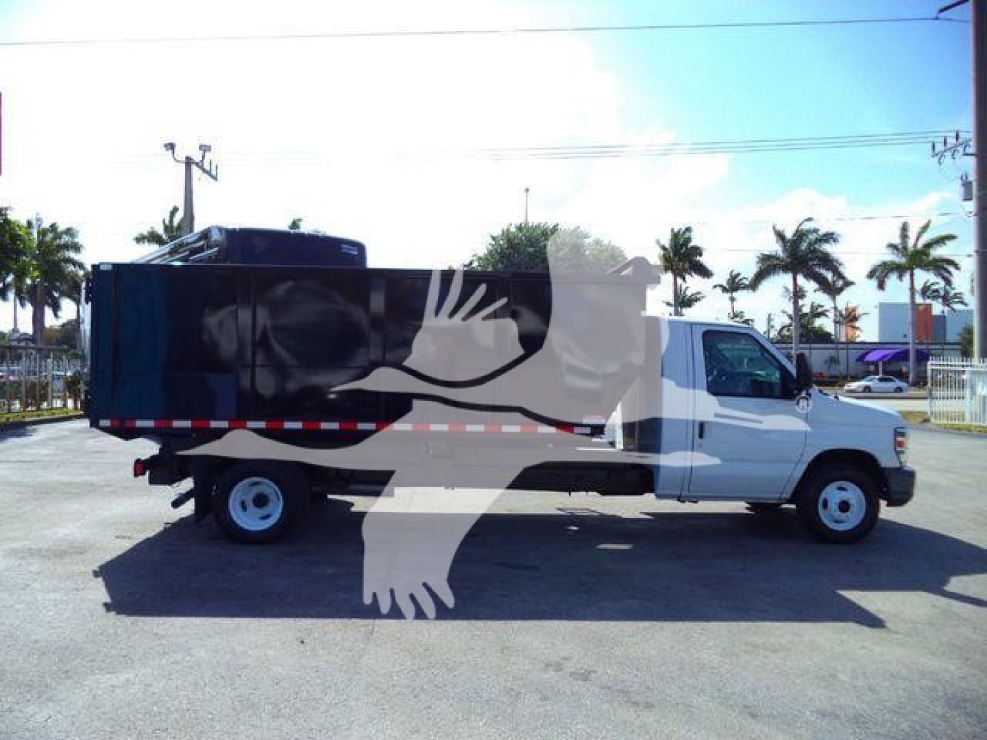 Ford E-Series cutaway truck 2011 with dump bed, side view showing dual-tone cargo area and white cab.