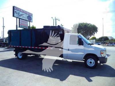 Ford E-450 dump truck with white cab and black dump bed, side view, logo of a flying bird overlay from watermark
