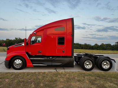 Kenworth T680 sleeper tractor, side view with red cab and black chassis. No visible text on decals or badges readable from this angle.