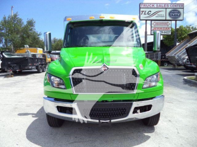 Green 2027 International MV rollback truck front view showing grille, headlights, chrome bumper, and hood emblem.