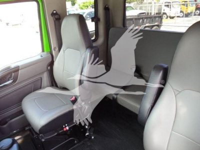 Cab interior of a new 2027 International MV rollback truck showing front seat and rear seating area with light gray upholstery.