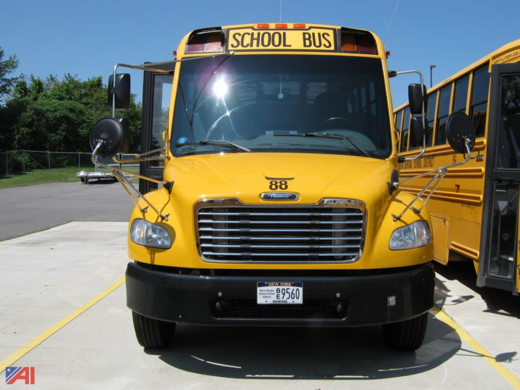 Front view of a yellow 2018 Freightliner C2 school bus with a black bumper, large grille, rounded headlights, and a 'SCHOOL BUS' sign above the windshield.