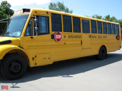 Yellow Freightliner C2 school bus side view showing stop sign and Central School District lettering