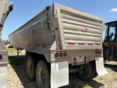 Travis Wave 37' dump trailer rear view showing metal cargo bed and taillights.