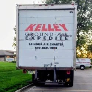 Truck rear with Kellogg Ground Air Express logo and text; number 55 in top right; white cargo door; faint text reading 24-HOUR AIR CHARTER and phone number; back of Freightliner M2 106 style.