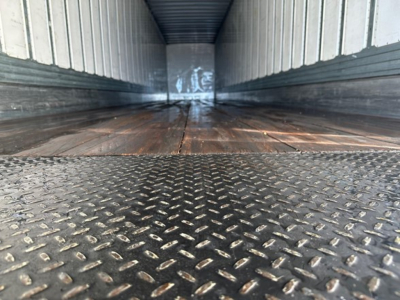 Trailer interior showing metal diamond-plate floor and empty cargo space in a Utility 4000Dx trailer.