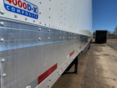 Utility 4000D-X trailer side showing aluminum riveted panels and 4000D-X composite logo.