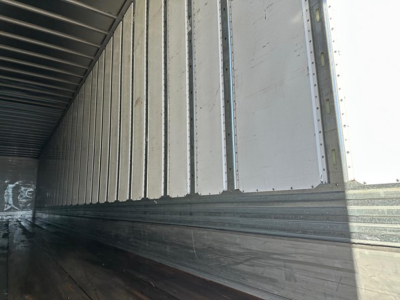Trailer interior showing metal side walls and ribbed ceiling from inside of a utility trailer.