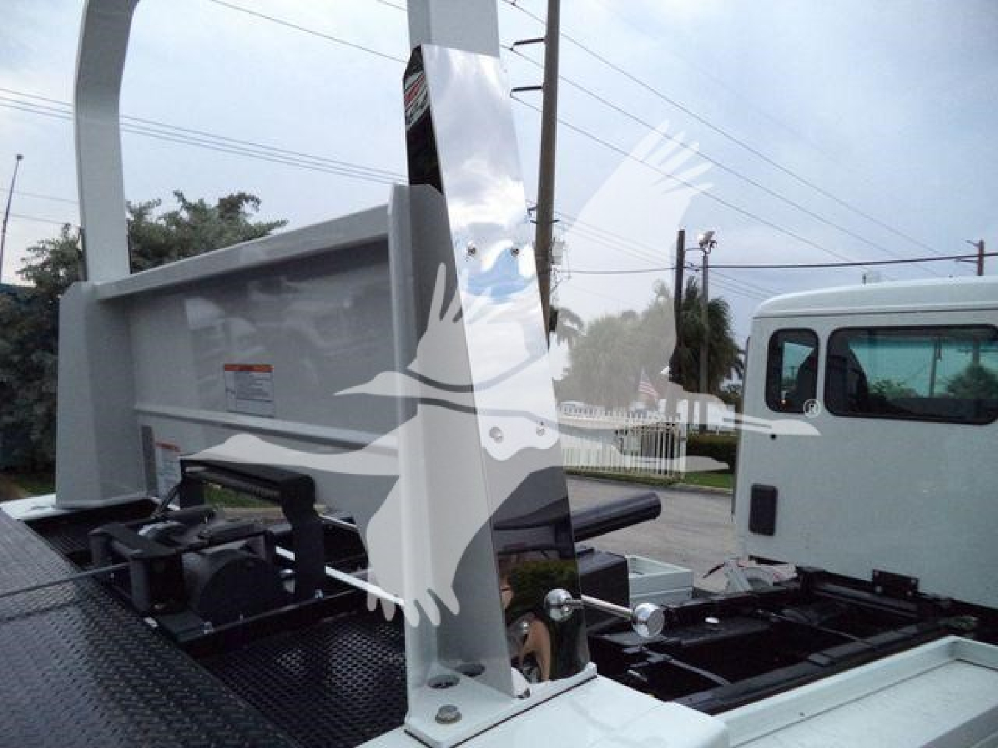 Kenworth T280 rollback truck bed with hydraulic components and cab visible; stock and category labels in the background.