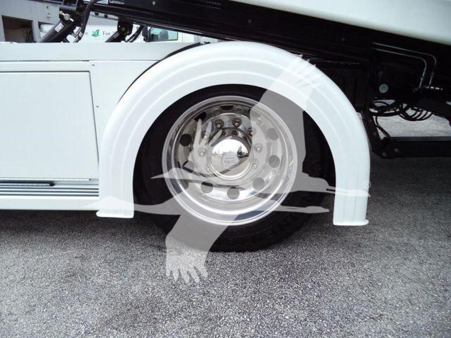 Kenworth T280 rollback truck front wheel and white fender showing wheel and undercarriage.